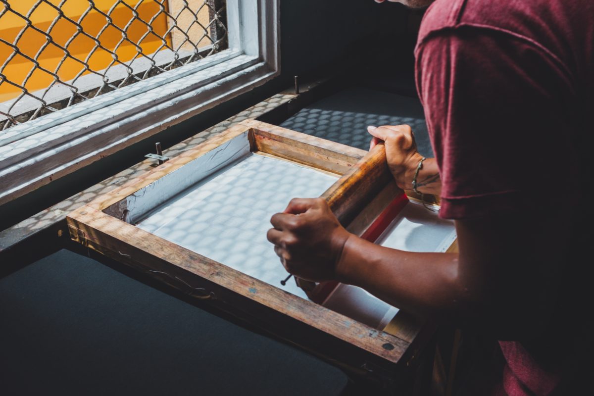 Man screen printing a shirt